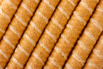 Close-up of striped wafer rolls. Background or texture